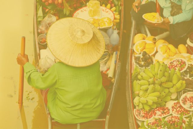 Woman in boat with fresh fruit