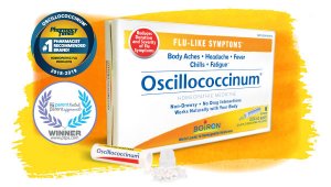 Oscillococcinum box and tube with pellets spilled out, against yellow and orange watercolor background and PTPA and Pharmacy Times awards